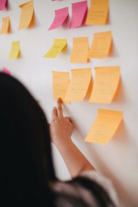 Woman hanging up post-it notes